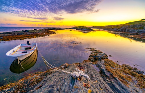 Beautiful seascape with small boat reflection. Location: Haugesund, Norway