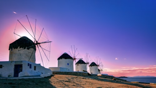 Traditional windmills, the symbol of Mykonos at sunset, Greece
