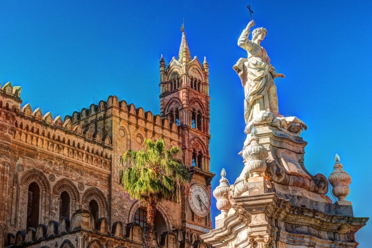 Sculpture in front of Palermo Cathedral church against blue sky, Sicily, Italy